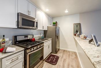 a kitchen with stainless steel appliances and white cabinets
